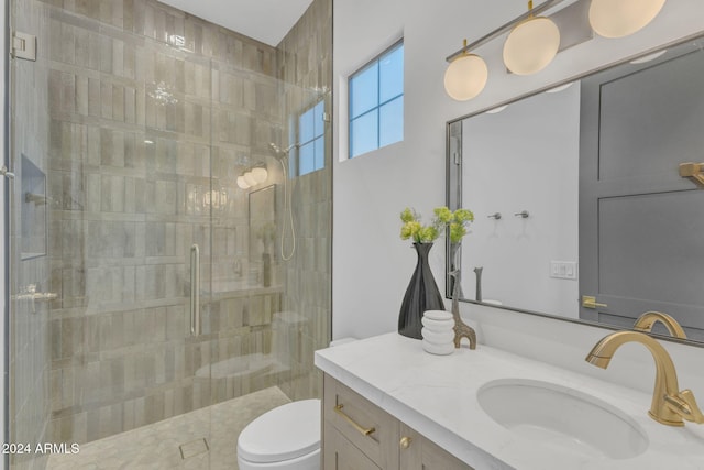 bathroom featuring vanity, toilet, and walk in shower