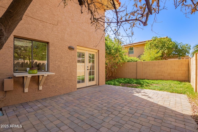 view of patio / terrace with french doors and fence