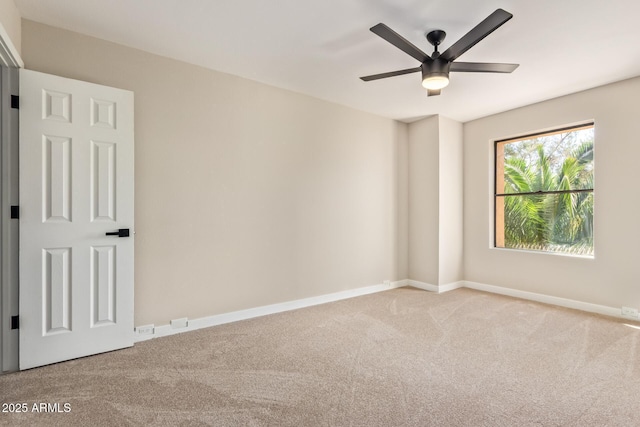 spare room featuring carpet floors, ceiling fan, and baseboards