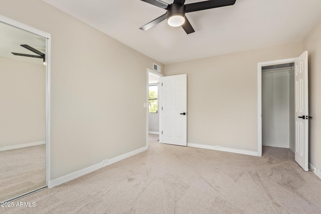 unfurnished bedroom featuring baseboards, visible vents, ceiling fan, and carpet flooring