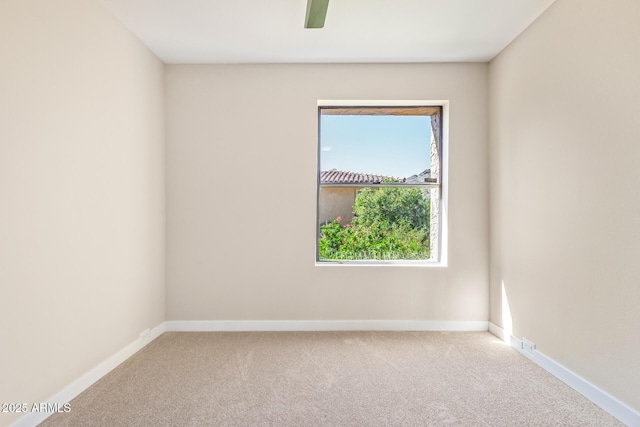 empty room with carpet floors and baseboards