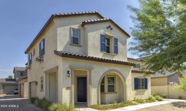 mediterranean / spanish-style house with a garage