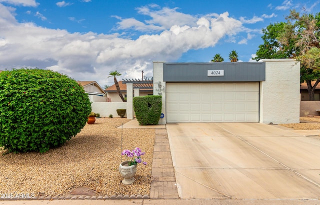 4024 W Griswold Rd, Phoenix, AZ 85051 - view of front of home with driveway, an attached garage, and stucco siding