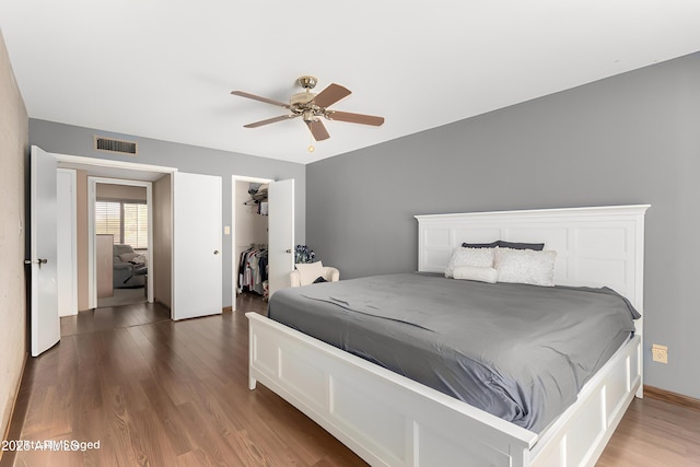 4024 W Griswold Rd, Phoenix, AZ 85051 - bedroom with wood finished floors, a spacious closet, a closet, and ceiling fan