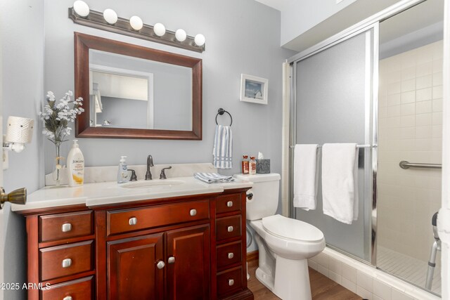 4024 W Griswold Rd, Phoenix, AZ 85051 - full bath with vanity, a shower stall, toilet, and wood finished floors