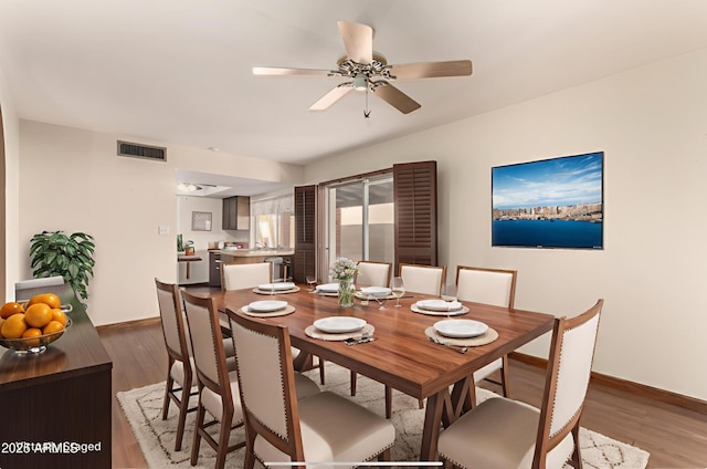 4024 W Griswold Rd, Phoenix, AZ 85051 - dining area with baseboards, wood finished floors, and ceiling fan