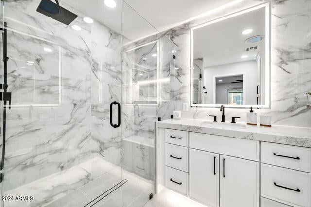 bathroom featuring vanity and a shower with shower door