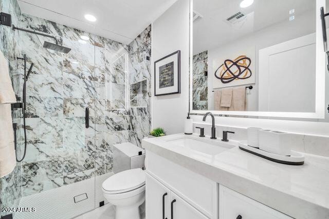 bathroom featuring vanity, toilet, and an enclosed shower