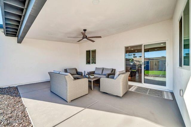 view of patio with an outdoor living space and ceiling fan