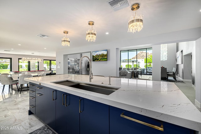 5404 N 41st St, Phoenix, AZ 85018 - kitchen with open floor plan, a sink, blue cabinets, a chandelier, and recessed lighting