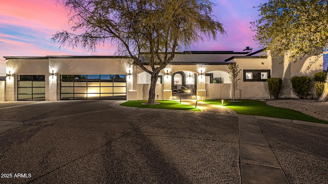 5404 N 41st St, Phoenix, AZ 85018 - view of front of home with stucco siding, driveway, an attached garage, and solar panels