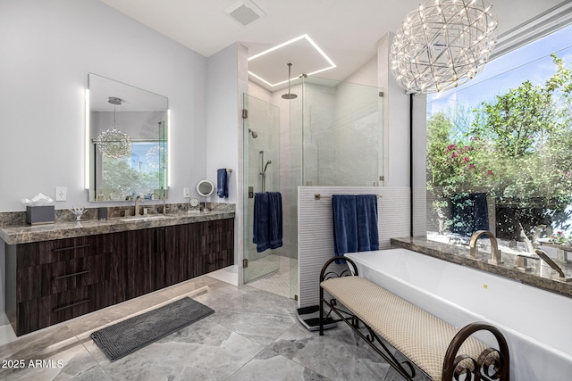5404 N 41st St, Phoenix, AZ 85018 - full bathroom featuring a stall shower, a soaking tub, vanity, a chandelier, and marble finish floors