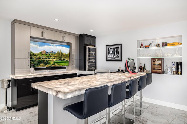 5404 N 41st St, Phoenix, AZ 85018 - kitchen with wine cooler, light countertops, a breakfast bar, light marble finish floors, and recessed lighting