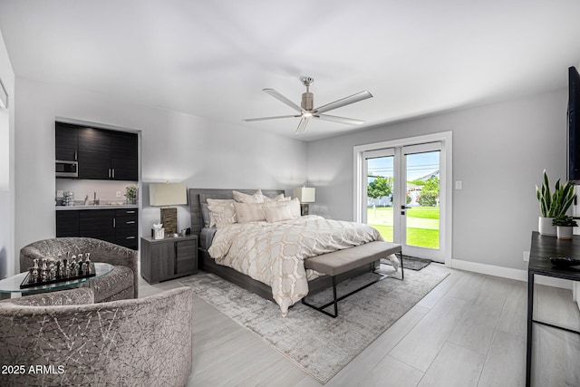 5404 N 41st St, Phoenix, AZ 85018 - bedroom with access to outside, light wood-style flooring, a sink, and baseboards