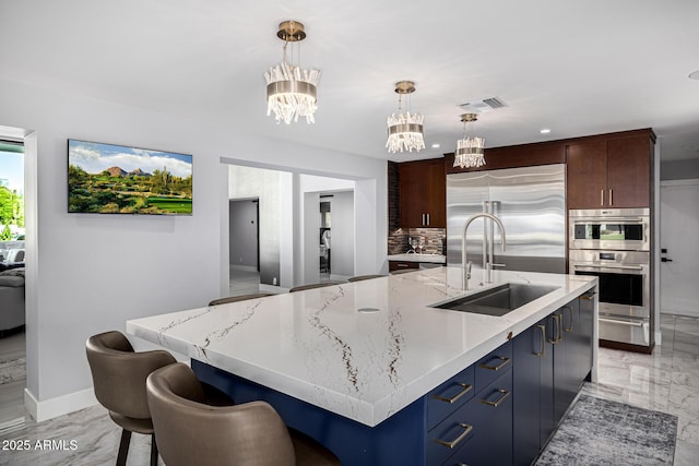 5404 N 41st St, Phoenix, AZ 85018 - kitchen with stainless steel appliances, a chandelier, a sink, decorative backsplash, and a warming drawer