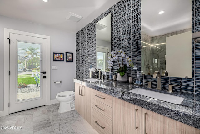 5404 N 41st St, Phoenix, AZ 85018 - full bath with double vanity, a shower stall, toilet, tasteful backsplash, and recessed lighting