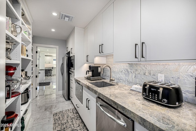 5404 N 41st St, Phoenix, AZ 85018 - kitchen featuring stainless steel appliances, a sink, decorative backsplash, light marble finish floors, and recessed lighting