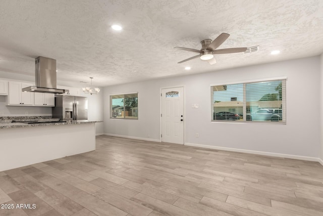 1028 W 5th St, Mesa, AZ 85201 - kitchen with stainless steel fridge, island range hood, a textured ceiling, a chandelier, and a ceiling fan