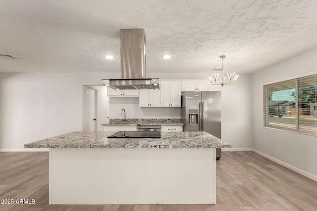 1028 W 5th St, Mesa, AZ 85201 - kitchen featuring island range hood, stainless steel refrigerator with ice dispenser, baseboards, a textured ceiling, and white cabinetry