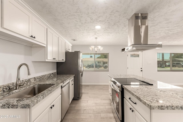 1028 W 5th St, Mesa, AZ 85201 - kitchen featuring stainless steel appliances, island range hood, a sink, a kitchen island, and white cabinetry