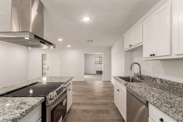 1028 W 5th St, Mesa, AZ 85201 - kitchen featuring stainless steel appliances, a sink, wall chimney exhaust hood, white cabinets, and wood finished floors