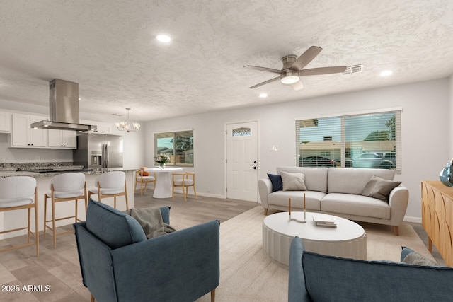 1028 W 5th St, Mesa, AZ 85201 - living area with light wood-type flooring, recessed lighting, a chandelier, ceiling fan, and a textured ceiling