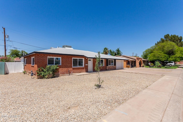 1028 W 5th St, Mesa, AZ 85201 - ranch-style home featuring a garage, concrete driveway, and brick siding
