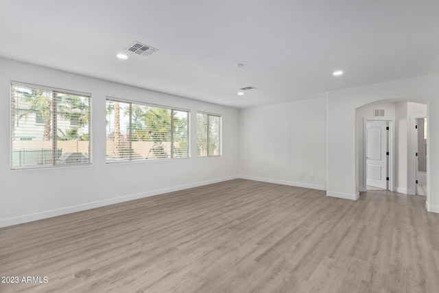 unfurnished room with plenty of natural light and light hardwood / wood-style flooring