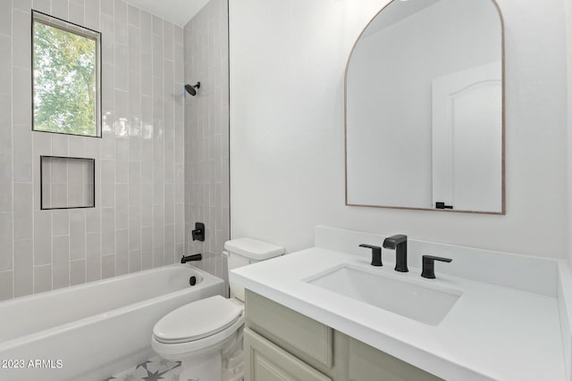 full bathroom featuring vanity, tiled shower / bath combo, and toilet