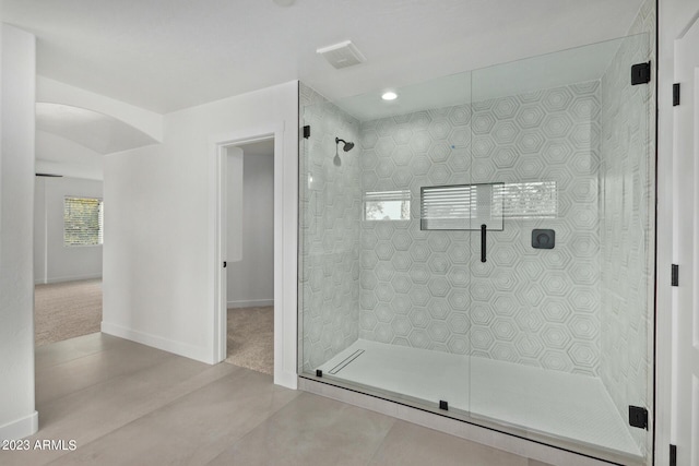 bathroom with a shower with door