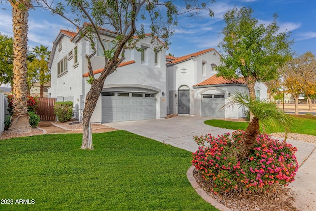 mediterranean / spanish-style home with a front lawn and a garage