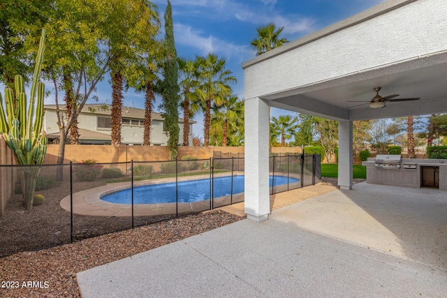 view of swimming pool with area for grilling, ceiling fan, and a patio