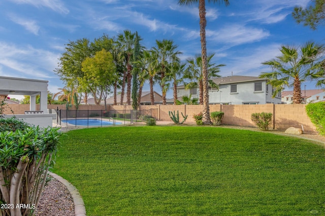 view of yard with a fenced in pool