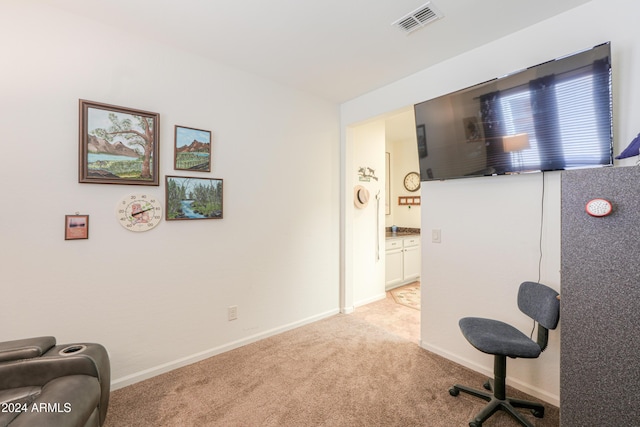 interior space with visible vents, light colored carpet, and baseboards