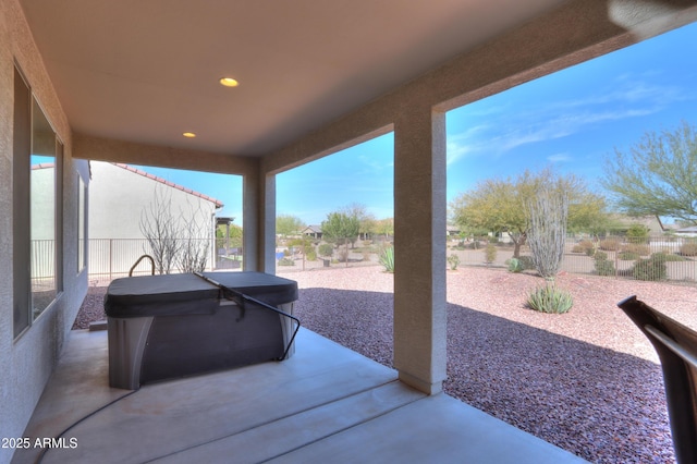 view of patio / terrace with a fenced backyard and a hot tub
