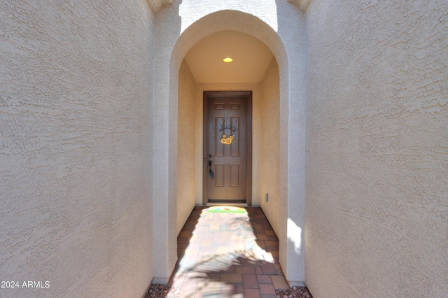 doorway to property featuring stucco siding