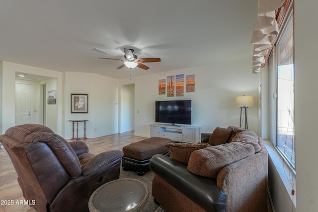 living room featuring ceiling fan and visible vents