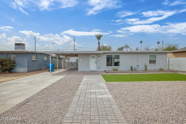 ranch-style house featuring a front yard and a carport