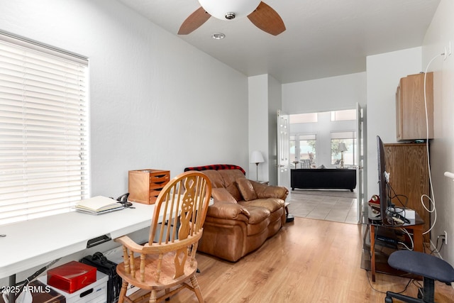 home office with ceiling fan and light wood-type flooring