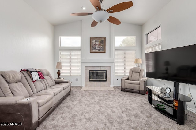 living room with carpet flooring, high vaulted ceiling, baseboards, a fireplace, and ceiling fan