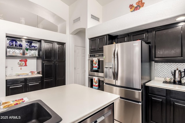 kitchen with visible vents, dark cabinetry, and appliances with stainless steel finishes