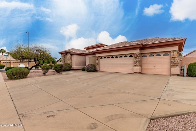 prairie-style house with a tile roof, stucco siding, concrete driveway, and a garage