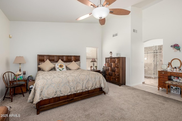bedroom featuring carpet floors, ceiling fan, visible vents, and tile patterned floors