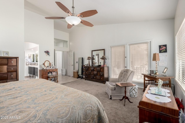 bedroom with a ceiling fan, high vaulted ceiling, carpet, and connected bathroom