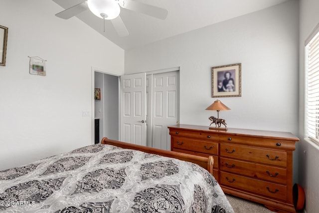 carpeted bedroom with lofted ceiling, a closet, and ceiling fan