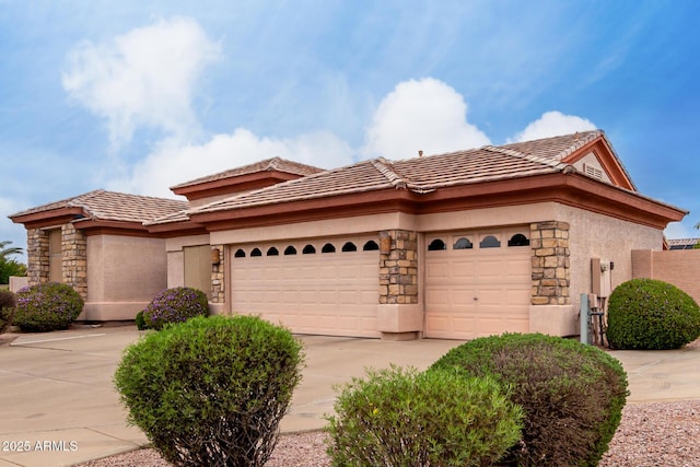 view of front of property with driveway, stucco siding, a garage, and stone siding