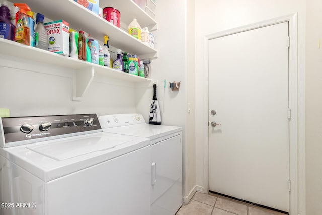 clothes washing area with light tile patterned flooring, separate washer and dryer, and laundry area