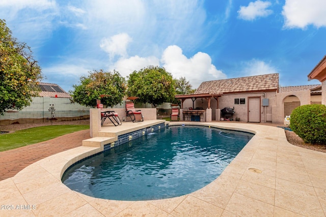 view of swimming pool with a patio, fence, a fenced in pool, and outdoor dry bar