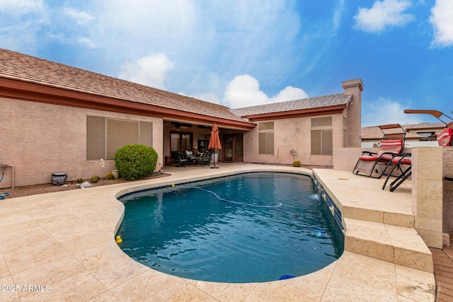 pool featuring ceiling fan and a patio