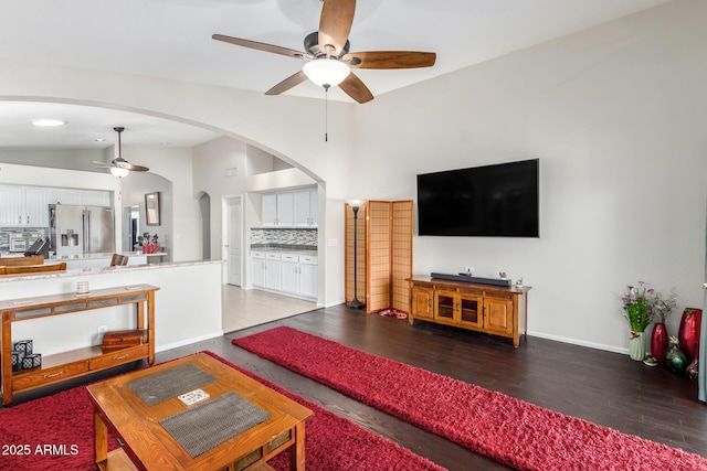 living room with vaulted ceiling, hardwood / wood-style floors, and ceiling fan